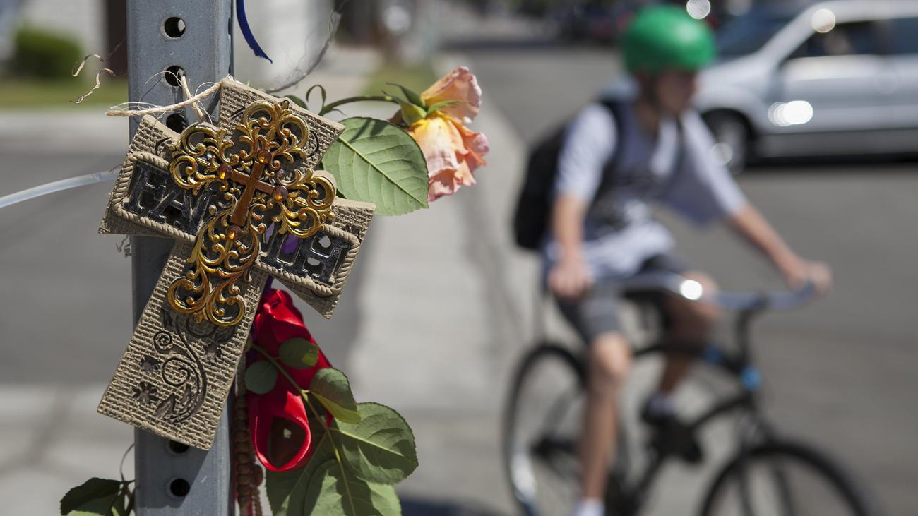 Items placed on a street sign help form a roadside memorial for an 8-year-old boy who was struck and killed by a truck Wednesday at 15th Street and Michael Place in Newport Beach.