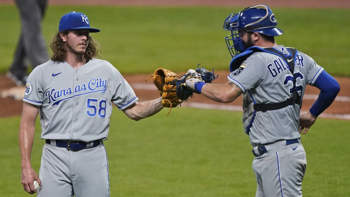 Kansas City Royals relief pitcher Scott Barlow is congratulated by Cam Gallagher after the Royals defeated the Cleveland Indians 8-6 in a baseball game Tuesday, Sept. 8, 2020, in Cleveland. (AP Photo/Tony Dejak)