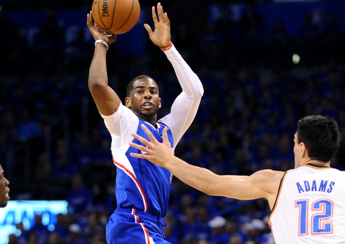 Clippers point guard Chris Paul makes a pass after going airborne in front of Thunder center Steven Adams. Paul finished with 10 assists in Game 1.