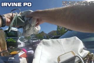 Body worn camera shows Irvine police officer arresting a shoplifter, left, who hid inside the trunk of her Tesla (in the background) after stealing $600 in Sephora products.