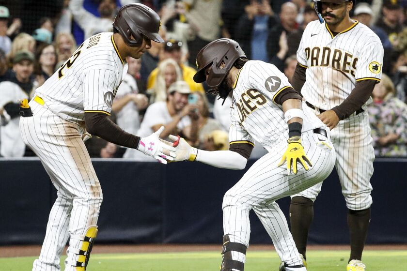 San Diego, CA - June 03: Padres left fielder Juan Soto (22) and Padres right fielder Fernando Tatis Jr. (23) celebrate Tatis' home run against the Cubs during the eighth inning at Petco Park on Saturday, June 3, 2023 in San Diego, CA. (Meg McLaughlin / The San Diego Union-Tribune)