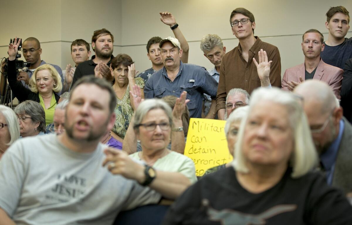 People listen at a public hearing about the Jade Helm 15 military training exercise in Bastrop, Texas, on April 27.