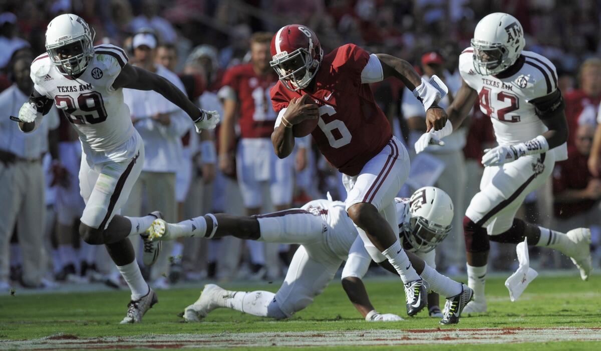 Alabama quarterback Blake Sims gets by Texas A&M defenders Deshazor Everett, left, Armani Watts and Otaro Alaka on his way to a 43-yard touchdown during the Crimson Tide's 59-0 victory Saturday in Tuscaloosa.