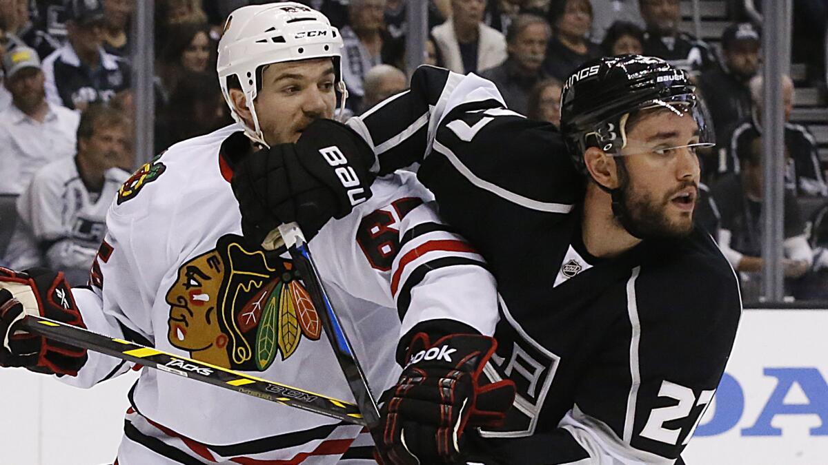 Kings defenseman Alec Martinez, right, battles with Chicago Blackhawks forward Andrew Shaw for position in front of goalie Jonathan Quick during the Kings' 5-2 win in Game 4 of the Western Conference finals Monday.