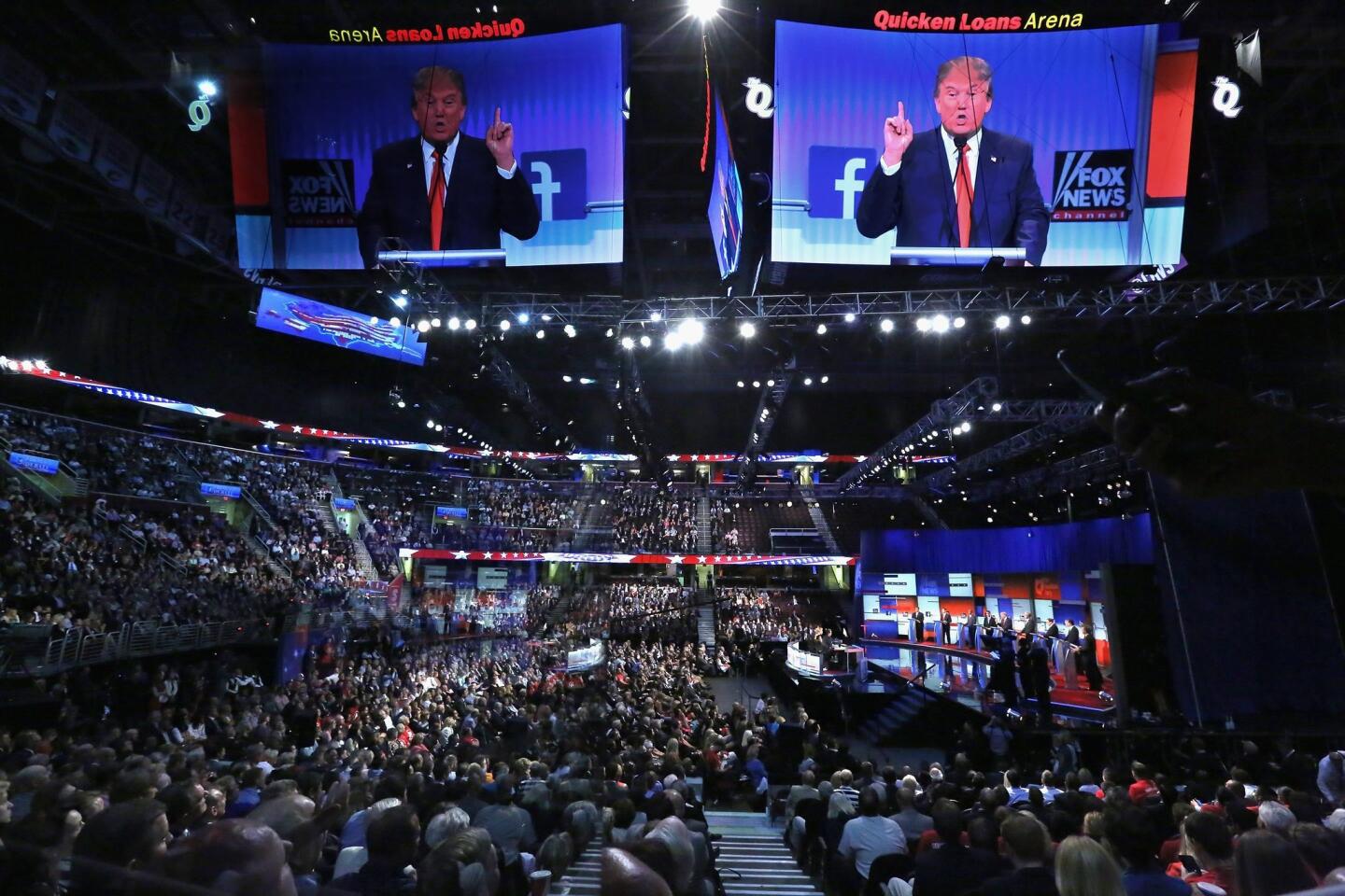 Donald Trump appears on a video screen above the crowd at Quicken Loans Arena in Cleveland.
