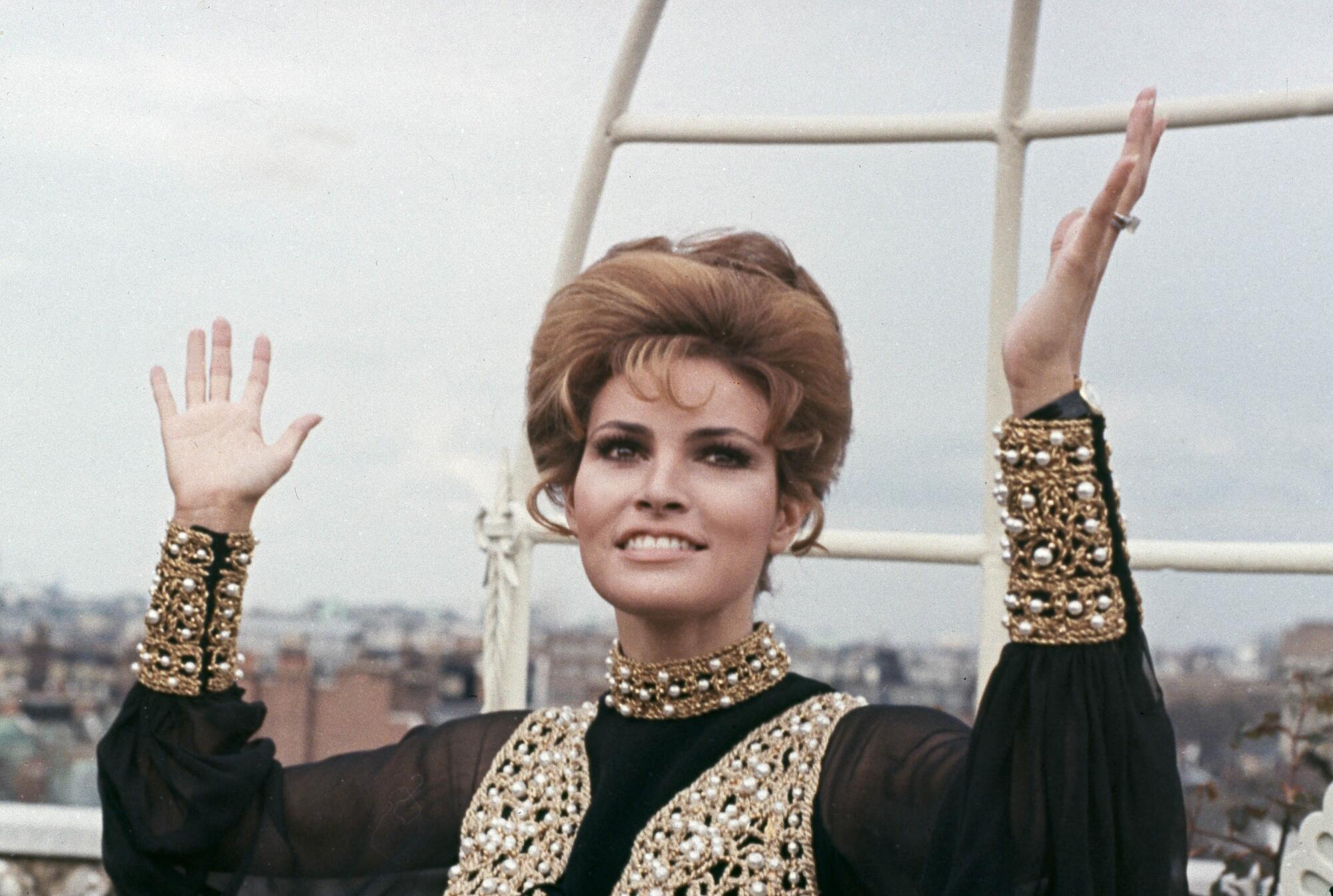 Actress Raquel Welch throws up her hands in dismay 