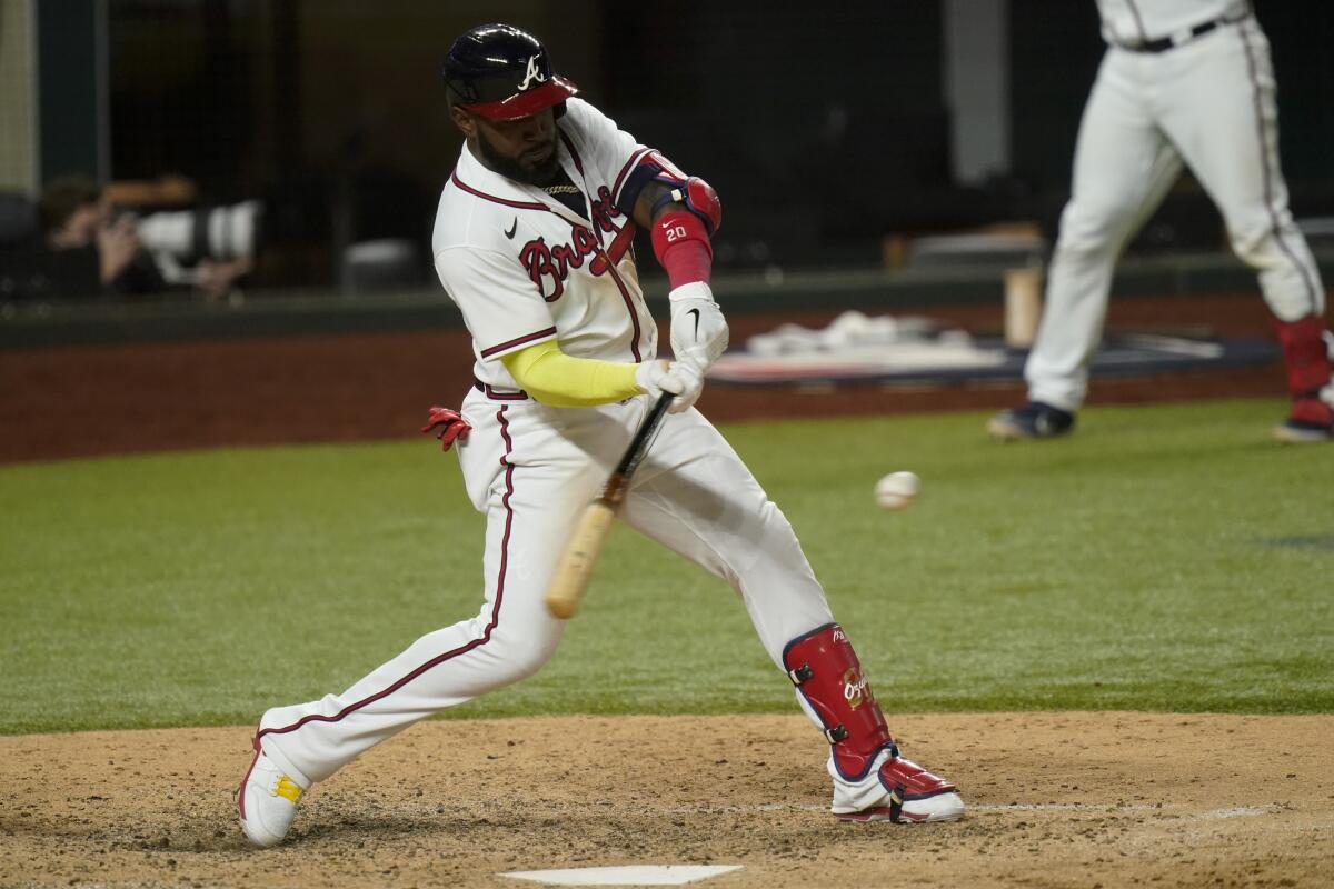 Atlanta's Marcell Ozuna hits a home run against the Dodgers in the seventh inning of Game 4.