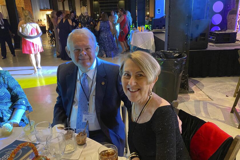 This photo shows Don and Margie Varnadoe attending a March 2021 awards banquet in Savannah, Ga., for the real estate office where Don Varnadoe worked. The husband and wife from St. Simons Island, Ga.,were among three people killed when an Amtrak train derailed in Montana on Saturday, Sept. 25, 2021. (Photo courtesy of Robert Kozlowski via AP)