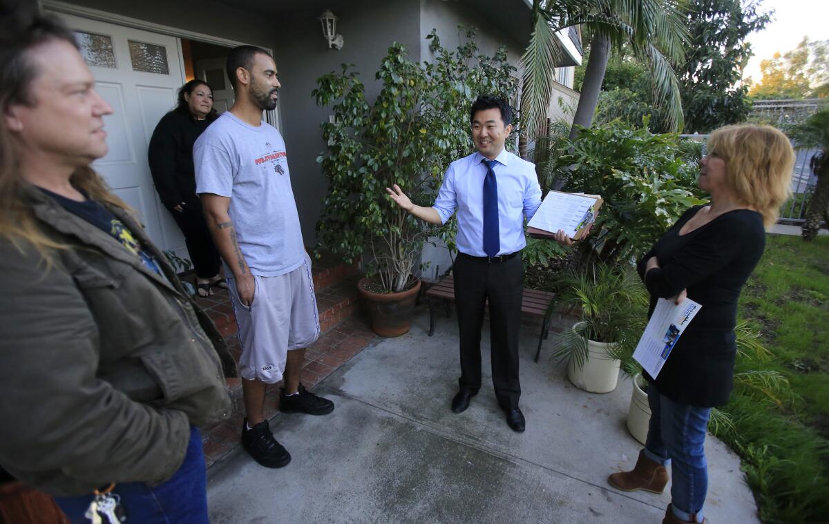 Los Angeles City Council District 4 candidate David Ryu talks with people on Addison Street while walking door-to-door on Dec. 13, 2014, in Sherman Oaks.