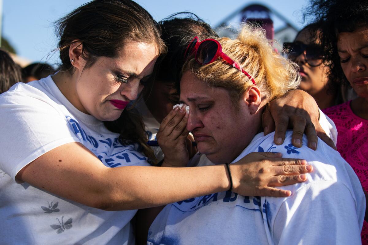 Katiuska Pimentel, left, aunt of Gilroy shooting victim Keyla Salazar, hugs Keyla’s parents Juan Salazar and Lorena de Salazar before a San Jose vigil.