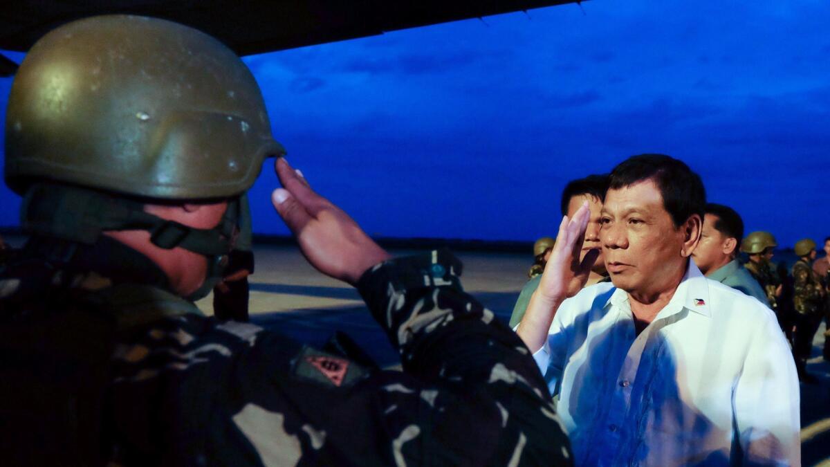 Philippine President Rodrigo Duterte salutes government troops Oct. 20, 2017, in Cagayan de Oro as they returned from combat against pro-Islamic State militants.