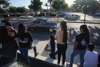 National City, California, USA September 21st, 2019 | San Diego Lowrider Association presents the first annual End of Summer Car Show in National City. After the car show lowrider cruise down Highland Avenue. Onlookers take photos and watch the lowriders pass by. | © Alejandro Tamayo, The San Diego Union Tribune 2019
