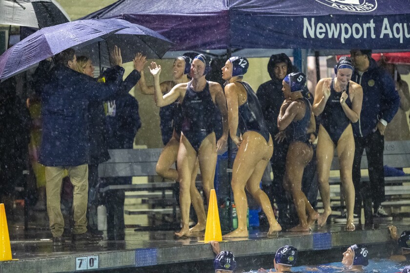 Newport Harbor girls' water polo team celebrates after beating Corona del Mar during the Battle of the Bay on Thursday.