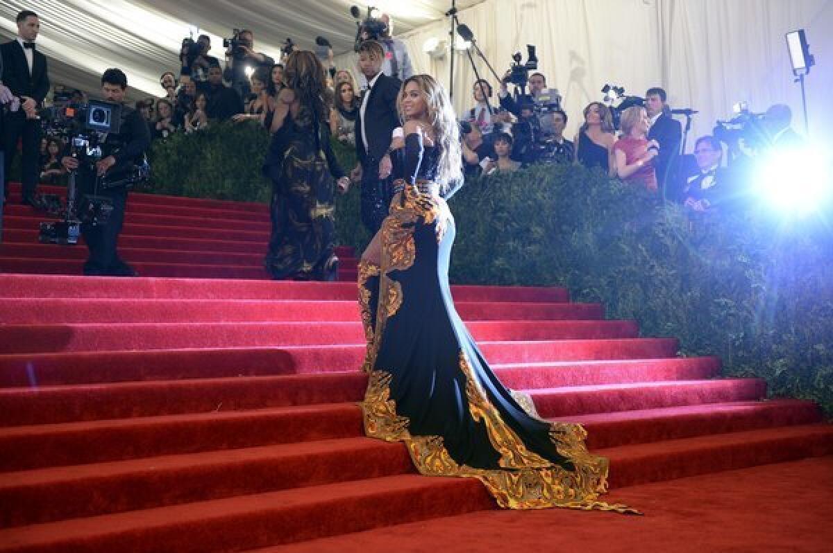 Beyonce, honorary chairwoman, arrives at the Metropolitan Museum of Art's Costume Institute Gala on Monday night wearing a Givenchy gown with sweeping train.