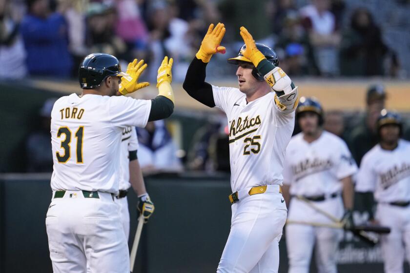 Oakland Athletics' Brent Rooker, right, celebrates with Abraham Toro after hitting a two-run home run against Miami Marlins pitcher Ryan Weathers during the fourth inning of a baseball game Friday, May 3, 2024, in Oakland, Calif. (AP Photo/Godofredo A. Vásquez)