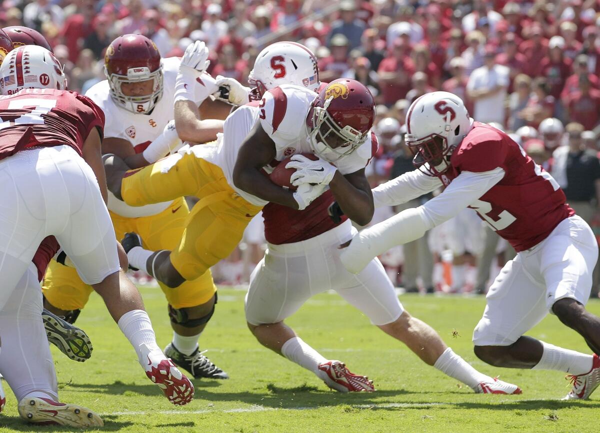 USC running back Justin Davis dives into the end zone to score on a 1-yard carry in front of Stanford safety Kyle Olugbode, right, during the first quarter of Saturday's game.