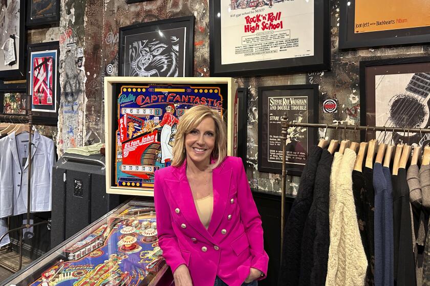 CNN broadcast journalist Alisyn Camerota poses at the former CBGBs nightclub, now a high-end men's clothing outlet, on March 29, 2024 in New York, to promote her memoir "Combat Love: A Story of Leaving, Longing, and Searching for Home." (AP Photo/Dave Bauder)