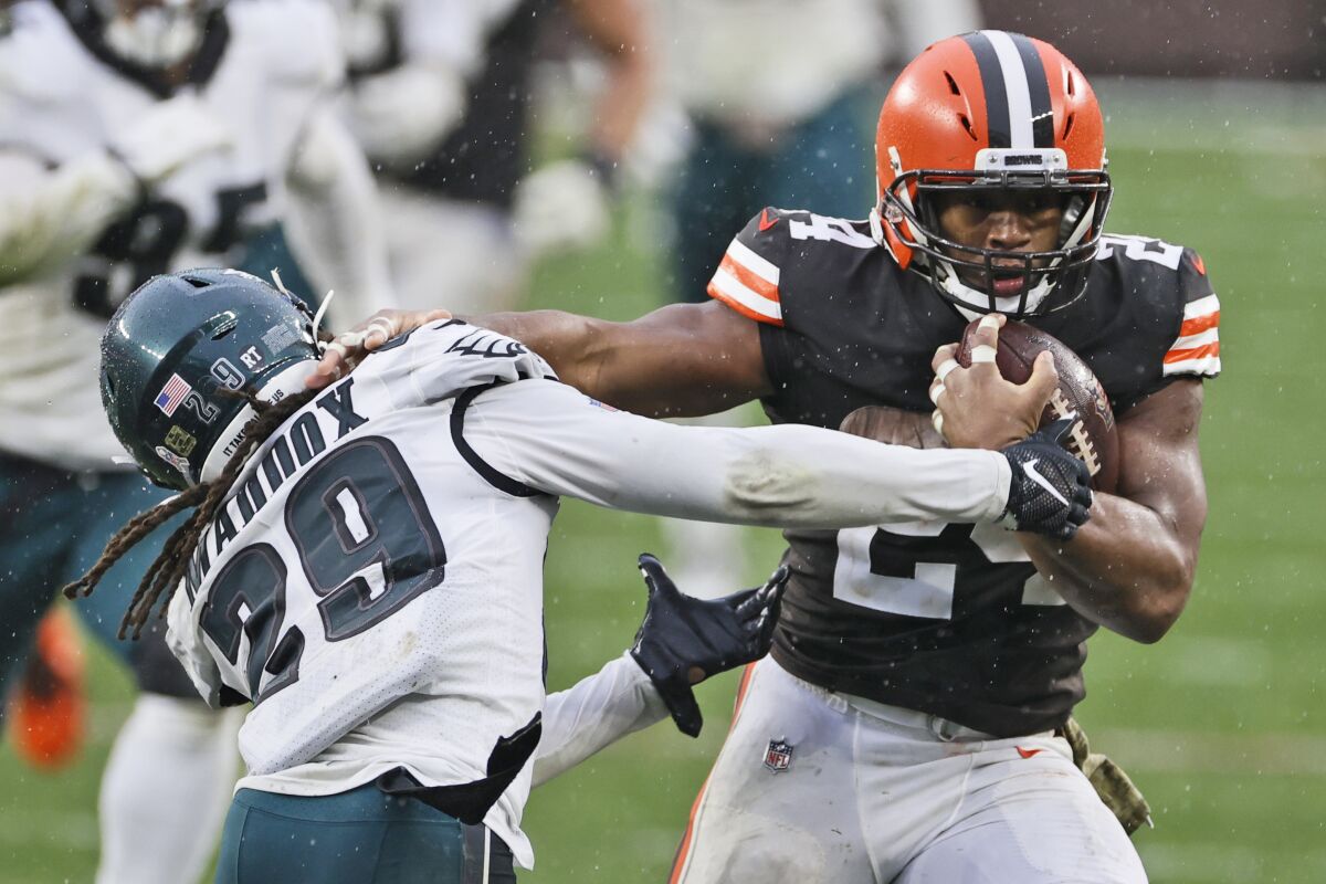 Cleveland Browns running back Nick Chubb (24) breaks a tackle by Philadelphia Eagles cornerback Avonte Maddox (29) during the second half of an NFL football game, Sunday, Nov. 22, 2020, in Cleveland. (AP Photo/Ron Schwane)