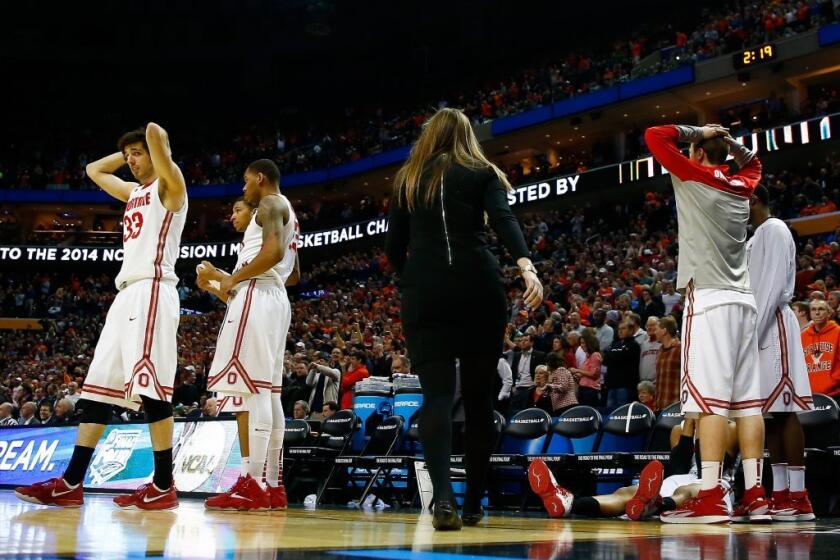 Members of Ohio State react after the loss to Dayton.