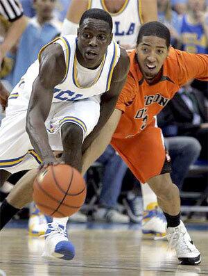 UCLA point guard Darren Collison tries to keep control of his dribble despite the steal attempt of Oregon State's Josh Tarver in the first half Thursday night.