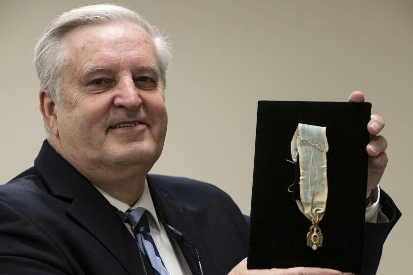 Displayed is Alexander Hamilton's Society of the Cincinnati Eagle insignia by Douglas Hamilton, his fifth great-grandson, at the Museum of the American Revolution in Philadelphia, Monday, Nov. 12, 2018. This and other items loaned by Douglas Hamilton will be featured as part of the museum's "Year of Hamilton." (AP Photo/Matt Rourke)