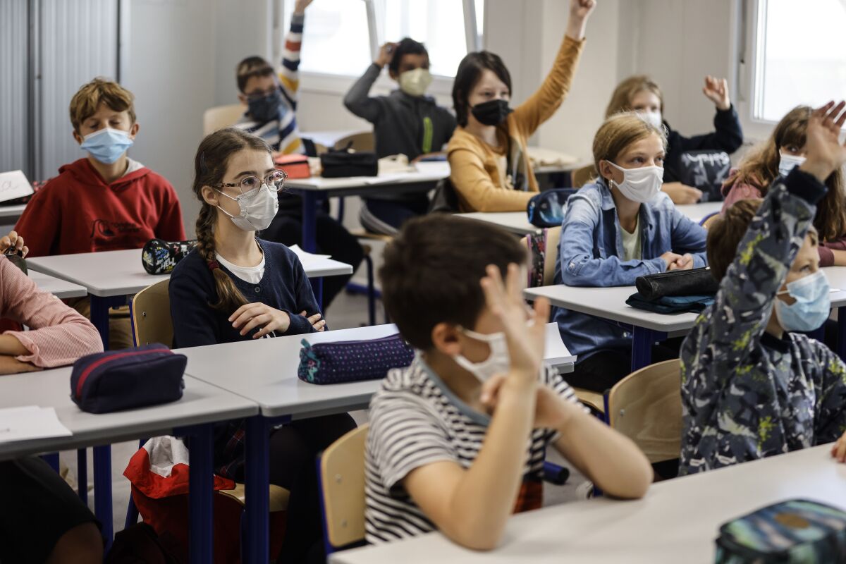 FILE - In this Sept. 2, 2021, file photo, children sit in a classroom at school in Strasbourg, eastern France. Children across Europe are going back to school, with hopes of a return to normality after 18 months of pandemic disruption and fears of a new surge in infections from the highly infectious delta variant of the coronavirus. (AP Photo/Jean-François Badias, File)