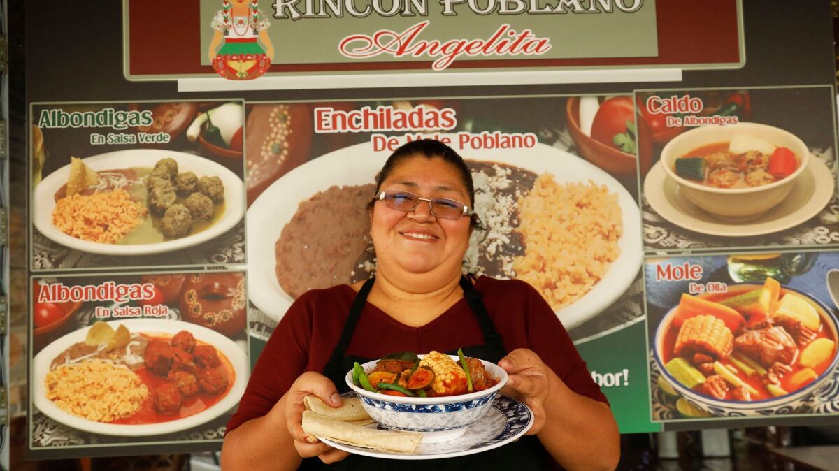 Lourdes Romero holds a bowl of mole de olla at Rincon Poblano Angelita on Whittier Boulevard.