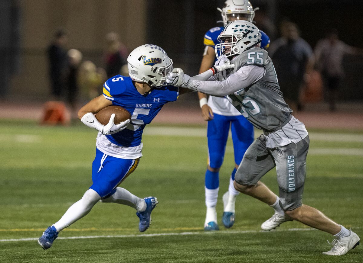 Fountain Valley's Adrian Esquivel draws a face-mask penalty against Aliso Niguel's Luke Guttenberg on Friday.