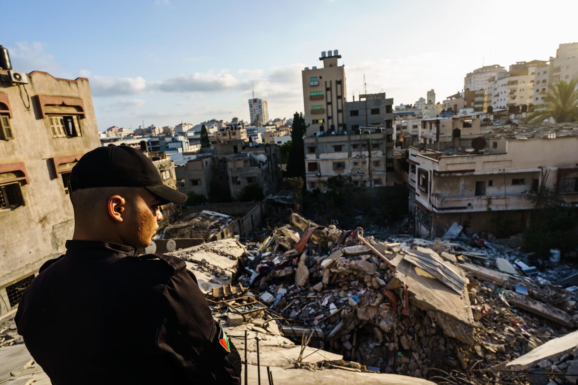 Police officer looking out over ruins 