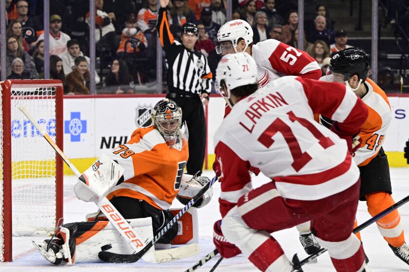 Philadelphia Flyers goaltender Carter Hart (79) makes a save on a shot from Detroit Red Wings' David Perron (57) during the third period of an NHL hockey game, Saturday, March 25, 2023, in Philadelphia. (AP Photo/Derik Hamilton)