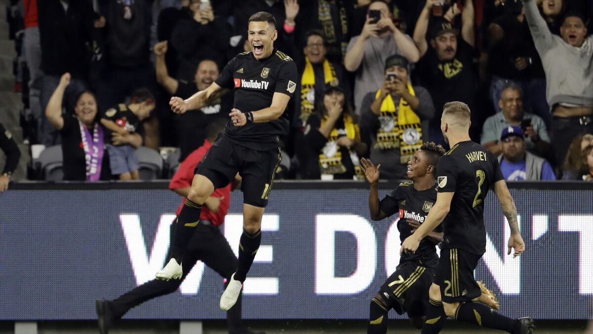 LAFC's Christian Ramirez, left, celebrates after scoring against Real Salt Lake during the second half of a playoff match on Thursday.