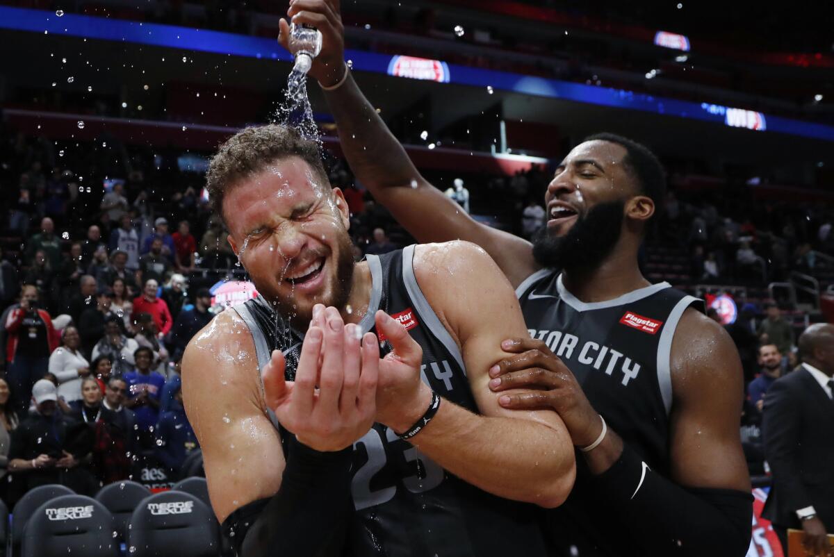 Detroit forward Blake Griffin is doused with water by teammate Andre Drummond after the Pistons defeated the Rockets 116-111 in overtime on Friday.