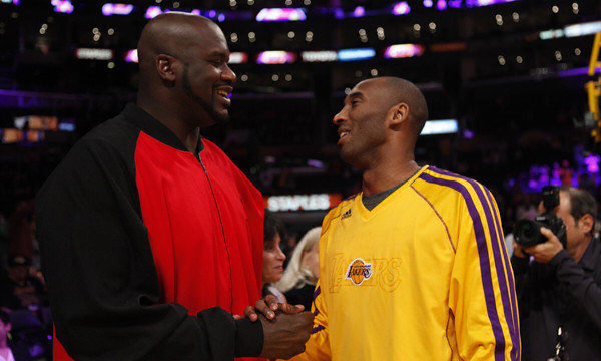 Shaquille O'Neal and Kobe Bryant chat before a game.