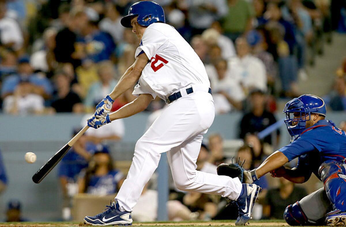Dodgers pitcher Zack Greinke drives in a run with a single against the Cubs during a game this summer at Dodger Stadium.