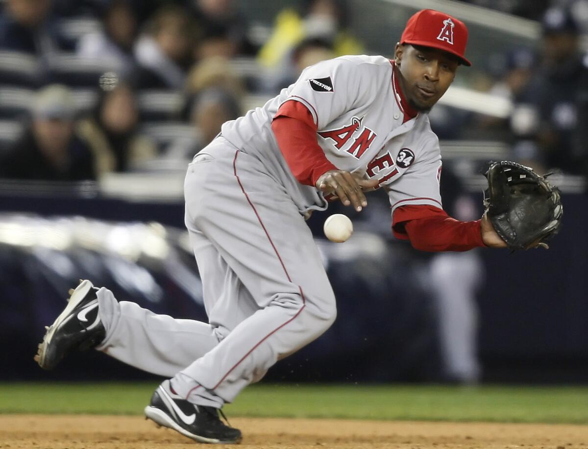 Angels third baseman Chone Figgins grabs a hit by Yankees batter Mark Teixeira during Game 2 of the American League Championship Series on Oct. 17, 2009.