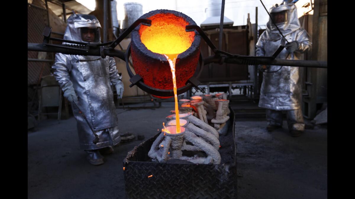 Molten bronze metal is poured into molds in the casting of the actor statuette at American Fine Arts Foundry in Burbank.
