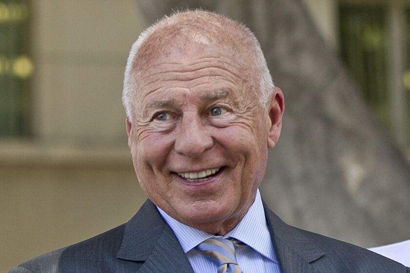 FILE - Attorney Tom Girardi smiles outside the Los Angeles courthouse on Wednesday, July 9, 2014. Disbarred attorney Girardi makes his first appearance Monday, Feb. 6, 2023, in federal court on charges that he embezzled millions of dollars from some of the large settlements he won for clients. (AP Photo/Damian Dovarganes, File)