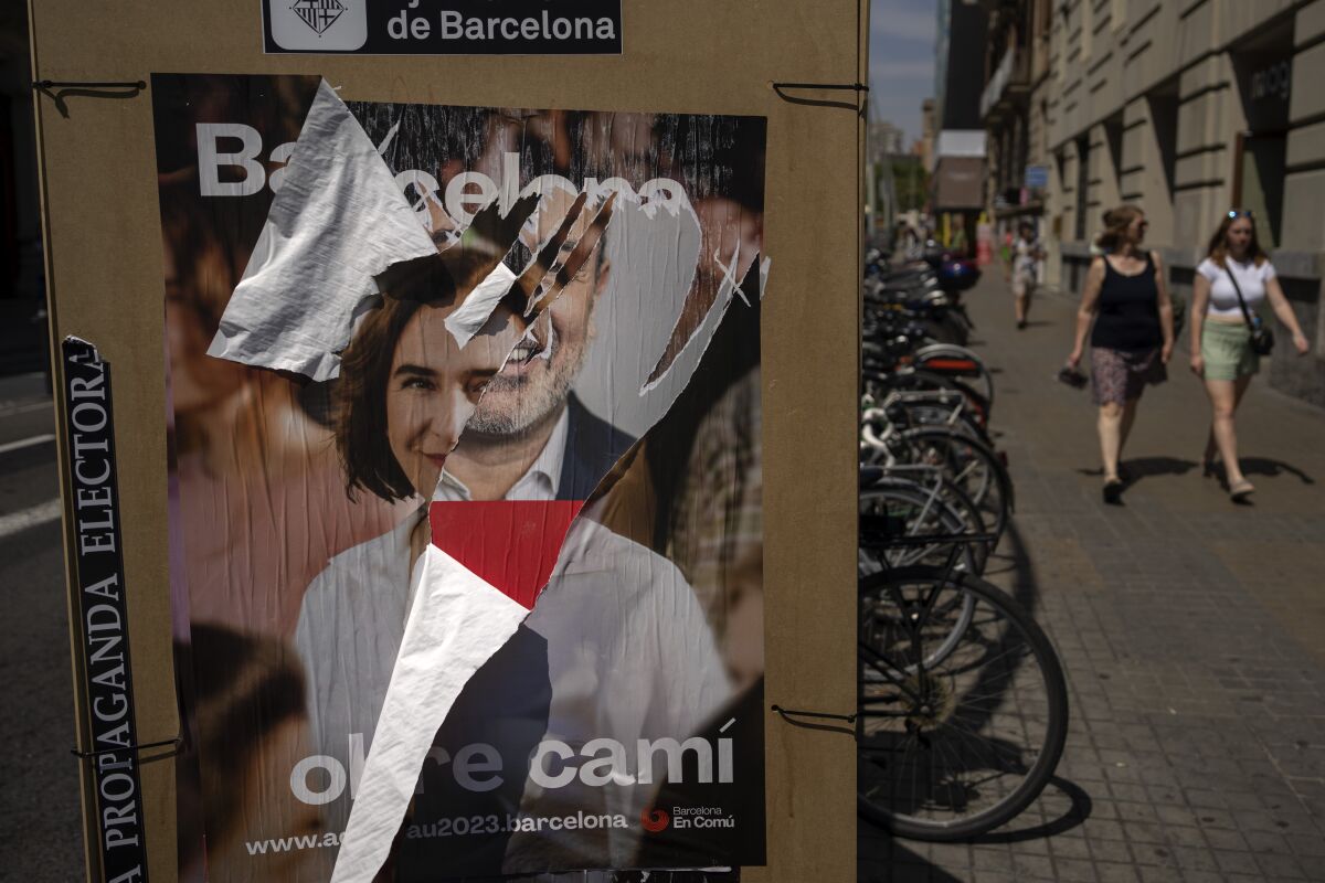 Electoral posters showing images of Barcelona's mayoral candidates for the next elections are photographed in Barcelona, Spain, Wednesday, May 24, 2023. Spain goes to the polls on Sunday for local and regional elections seen as a bellwether for a national vote in December, with the conservative Popular Party (PP) steadily gaining ground on the ruling Socialists in key regions. (AP Photo/Emilio Morenatti)