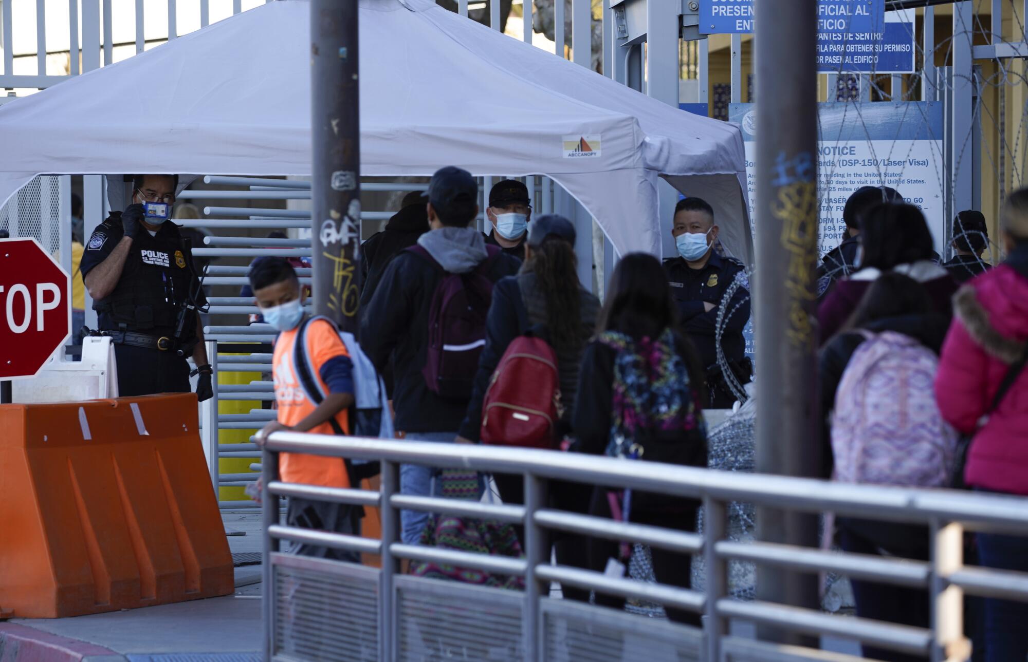 Pedestrians stand in line