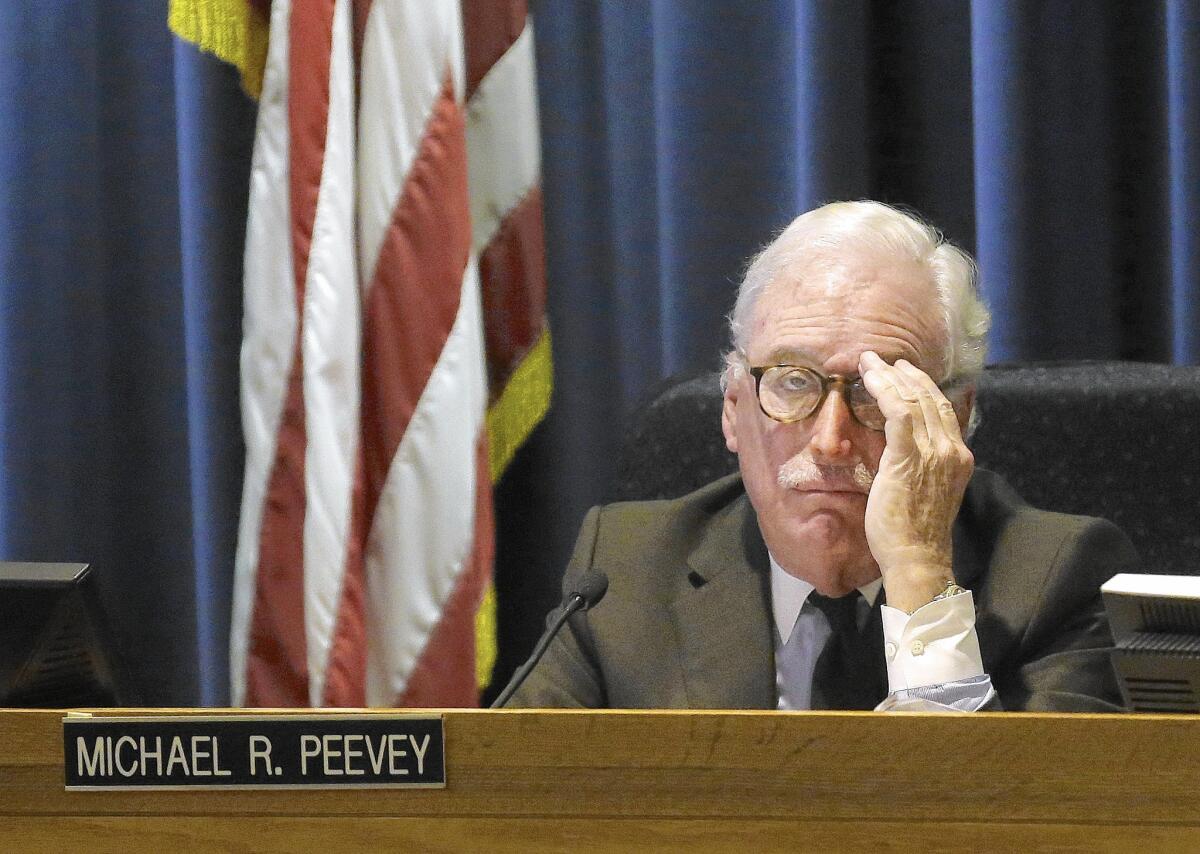 Michael Peevey, former president of the California Public Utilities Commission, listens to comment during a meeting of the five-member commission in San Francisco in 2014.