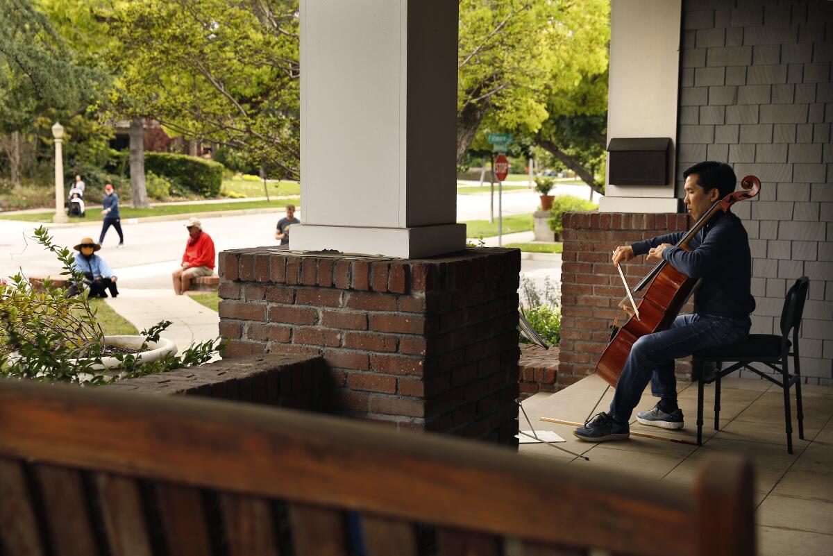 Beong-Soo Kim plays cello on the porch of his home in Pasadena. 