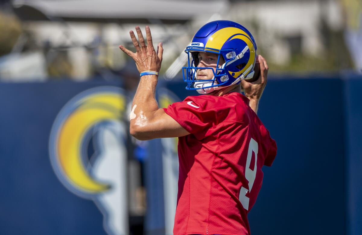 Rams starting quarterback Matthew Stafford looks to pass during camp practice.