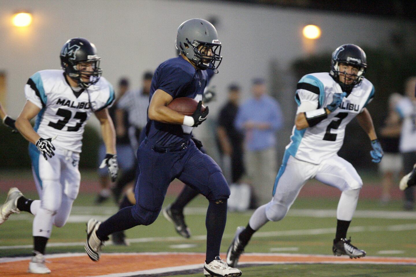 Flintridge Prep's Stefan Smith, center, runs with the ball during a game against Malibu at Occidental College in Los Angeles on Friday, September 21, 2012.