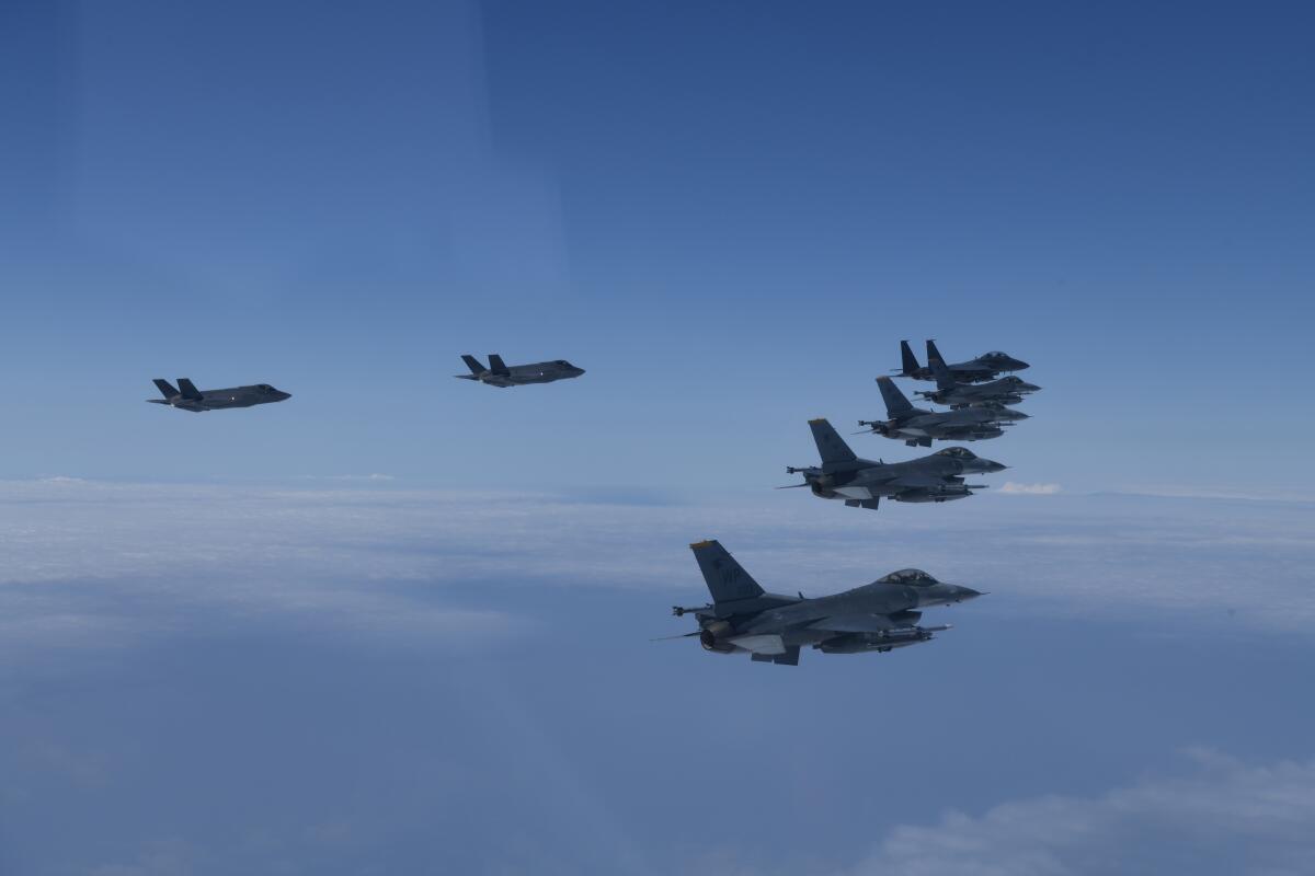 In this photo provided by South Korea Defense Ministry, U.S. and South Korea Air Force fighter jets fly in formation during a joint drill on Tuesday, June, 7, 2022. The South Korean and U.S. militaries flew 20 fighter jets over South Korea's western sea Tuesday in a continued show of force as a senior U.S. official warned of a forceful response if North Korea goes ahead with its first nuclear test explosion in nearly five years. (South Korea Defense Ministry via AP)