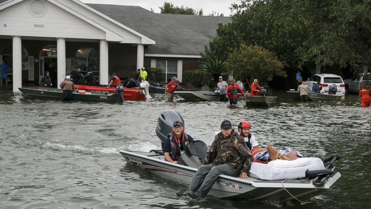 Volunteer boaters transport residents from the Cypress Glen nursing home in Port Arthur, Texas.