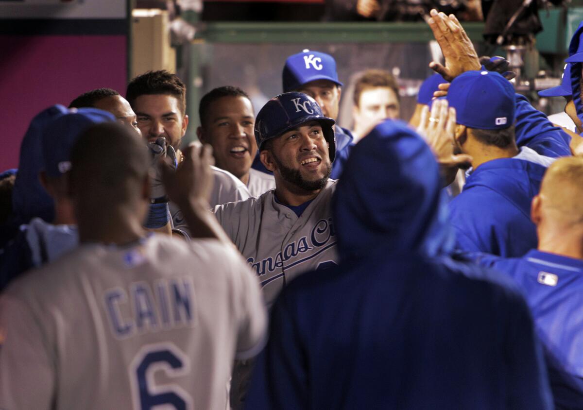 Designated hitter Kendrys Morales is congratulated by teammates after hitting a solo home run in the sixth inning to give the Royals a 3-1 lead over the Angels.