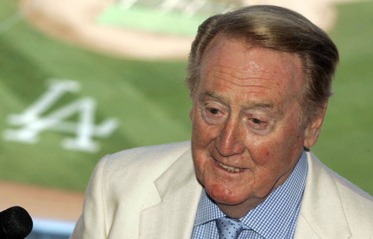 Vin Scully spends his birthday at home reading a book.