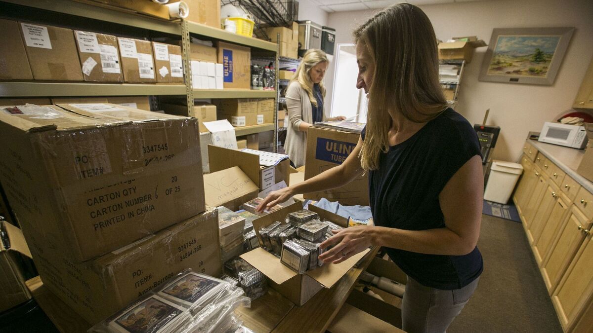 Brianna Puzzo, foreground, assistant executive director of the Anza-Borrego Foundation, and Bri Fordem, rear, executive director, sort through some of the extra merchandise that they have stocked up on at the gift shop for the upcoming wildflower season.