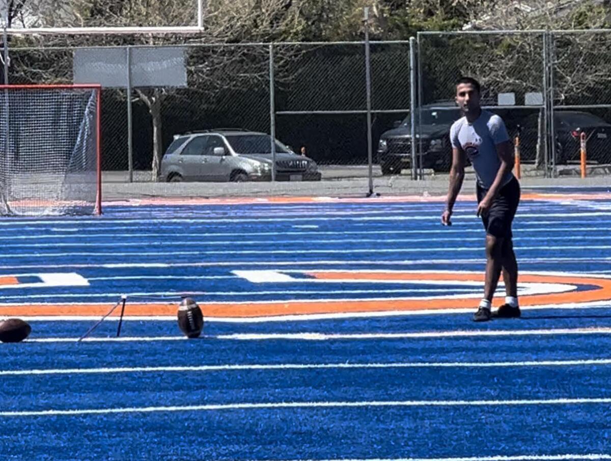Ryon Sayeri of Chaminade sets up for a field goal using a special tee at the school's football field.