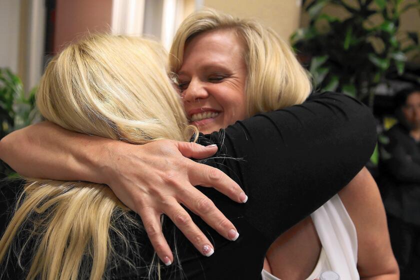 City of Industry council candidate Cory Moss, right, celebrates her win as she hugs Mary Radecki, wife of fellow winning candidate Mark Radecki.